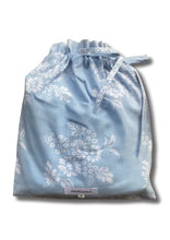 Load image into Gallery viewer, A light blue drawstring pouch with a white floral pattern, packaging for the set