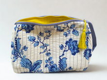 Load image into Gallery viewer, Cosmetic bag with blue floral pattern and yellow tassel , contrast yellow inside.
