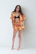 Load image into Gallery viewer, Woman wearing a yellow floral kimono and shorts on a white background