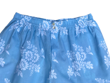 Load image into Gallery viewer, Blue boxer briefs with white floral pattern on a white background
