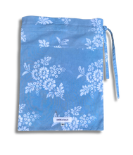 Load image into Gallery viewer, Blue pouch with white floral pattern on a white background