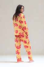 Load image into Gallery viewer, Woman wearing a yellow and pink floral pajama set against a plain background
