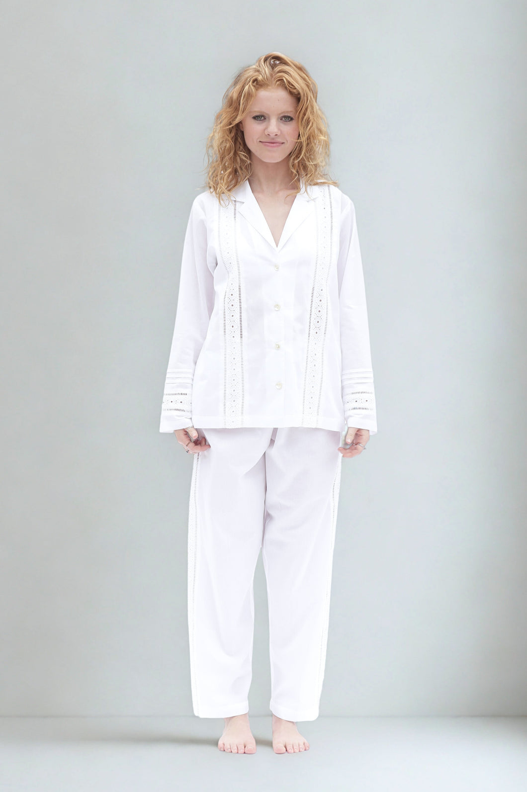 Woman wearing a white long sleeve pyjama set 
