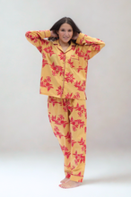 Load image into Gallery viewer, Woman wearing a yellow and red floral pajama set on a white background
