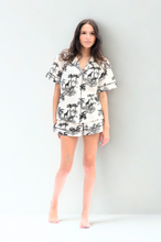 Load image into Gallery viewer, Woman wearing a tropical short pyjama set on a white background
