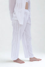 Load image into Gallery viewer, White pants with decorative trim on a white background
