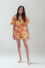 Load image into Gallery viewer, Woman wearing a yellow floral pajama set on a white background
