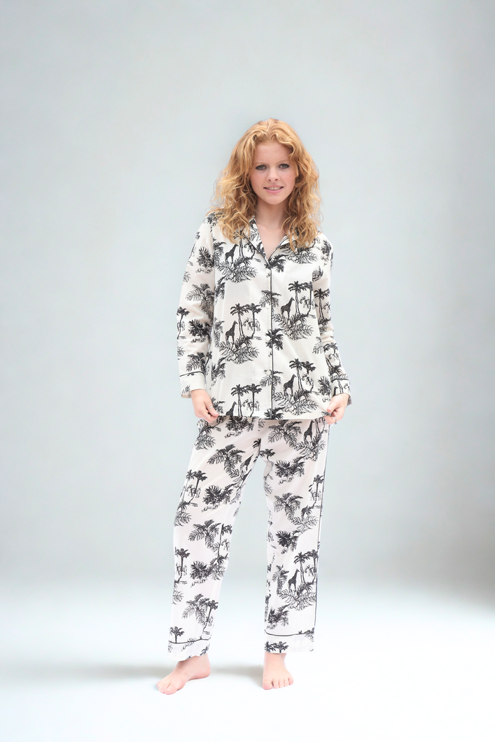 Woman wearing along sleeve pyjama set on a plain background