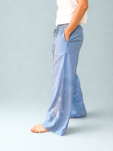 Load image into Gallery viewer, Person wearing blue and white striped pants with side embroidery
